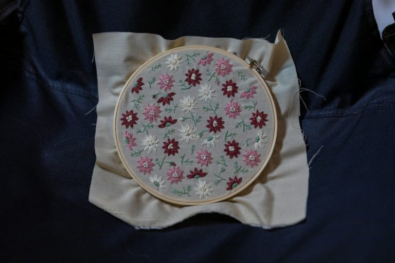 Close up stitching and fabric texture showing floral threadwork